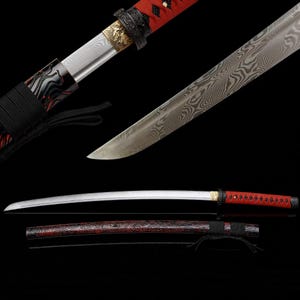 May include: A katana sword featuring a blade with a visible folded steel pattern, a red wrapped handle, and a gold-toned metal collar. The matching scabbard is black with red marbled detailing and a black cord wrap, shown both assembled and disassembled.
