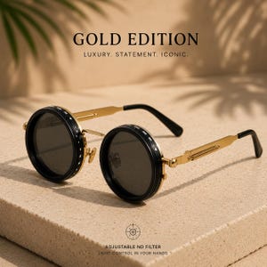 May include: Gold-coloured sunglasses with round black lenses and black rims. The frames have a gold finish with black temples. The text "GOLD EDITION" and "LUXURY. STATEMENT. ICONIC." are visible. The text "ADJUSTABLE ND FILTER LIGHT CONTROL IN YOUR HANDS" is also visible.