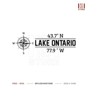 May include: A black graphic design featuring a compass rose on the left, with the text 43.7° N, LAKE ONTARIO, and 77.9° W stacked on the right. The design includes horizontal lines above and below the text, with MY LEE HO STORE in the corner.