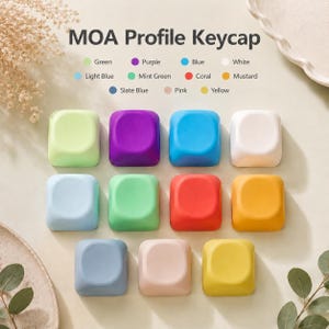 May include: A collection of eleven square MOA profile keycaps in various solid colors including green, purple, blue, white, light blue, mint green, coral, mustard, slate blue, pink, and yellow, arranged in a grid with a color legend above.