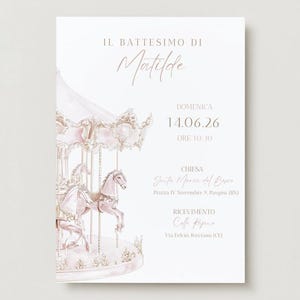 May include: A pale pink invitation card featuring a carousel illustration. The text reads "Il Battesimo di Matilde" and includes the date, time, church, and reception details. The carousel has pink horses and decorative elements.