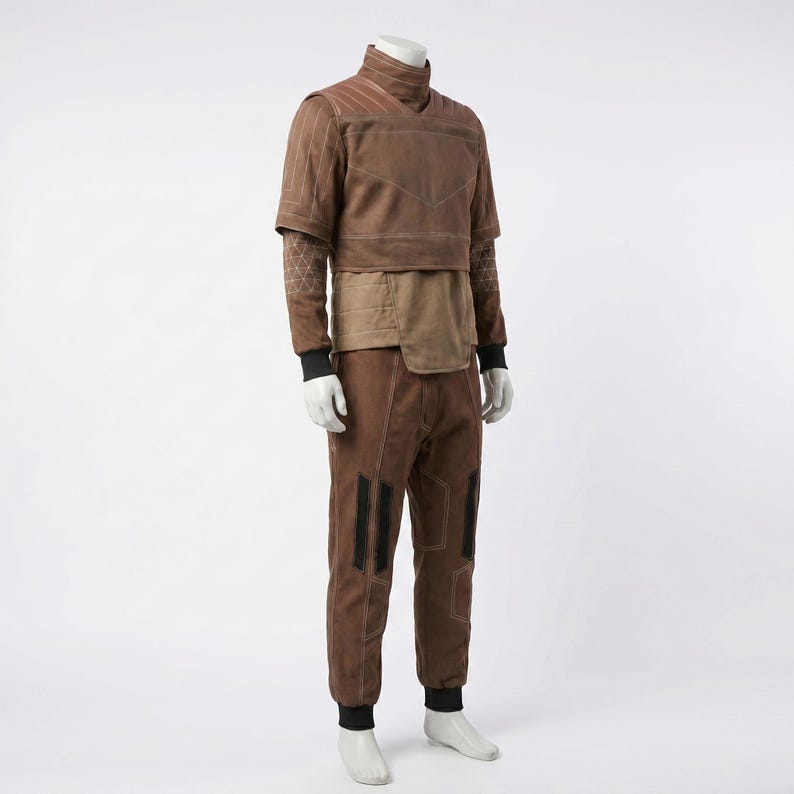 May include: A brown two-piece outfit consisting of a short-sleeved top with a high collar and matching trousers. The top features light-colored stitching, a layered midsection, and patterned sleeves. The trousers include vertical black accents.
