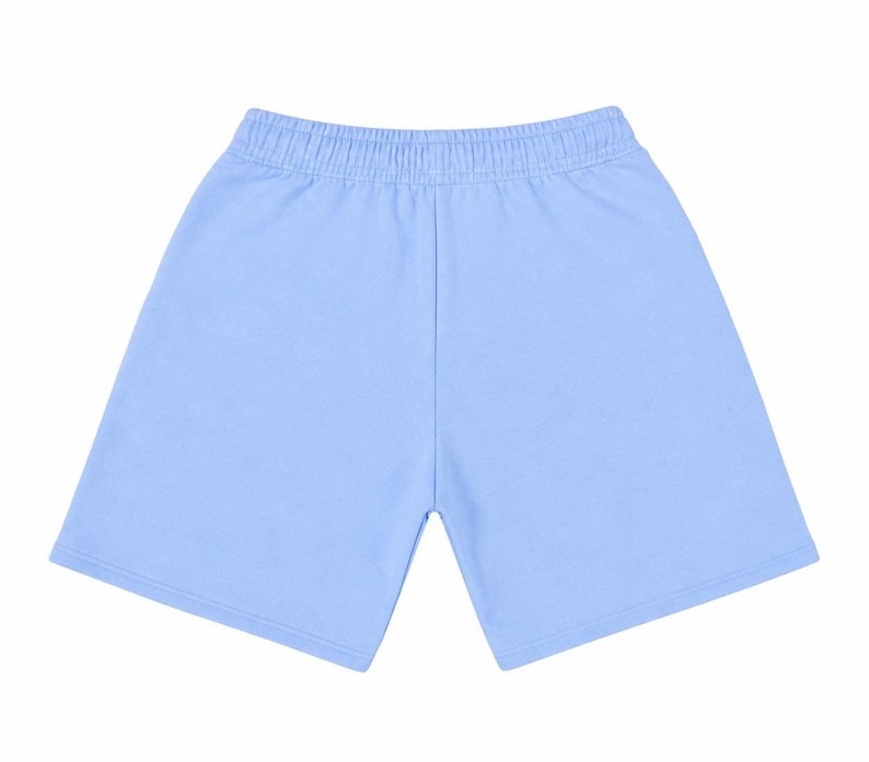 May include: Light blue shorts with an elastic waistband. The shorts are made of a soft material and have a simple, classic design. The shorts are a solid color and are suitable for casual wear.