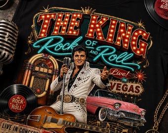 May include: A black t-shirt featuring a graphic of Elvis Presley in a white jumpsuit holding a microphone. The design includes a jukebox, a pink vintage car, a guitar, and text reading THE KING OF ROCK AND ROLL LIVE IN VEGAS.