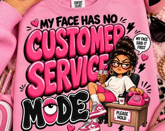 May include: A light pink sweatshirt featuring a graphic print with the text "MY FACE HAS NO CUSTOMER SERVICE MODE" and "MY FACE SAID IT FIRST". The design includes a cartoon character at a desk with a pink telephone and a "PLEASE HOLD" sign.