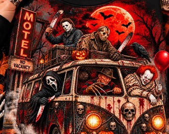 May include: A black t-shirt featuring a graphic print of a vintage van decorated with skulls and pumpkins. The van is occupied by horror movie characters, including a masked figure, a man with a clawed glove, and a clown holding a red balloon.