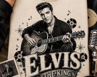 May include: A beige crewneck sweatshirt featuring a black and white graphic of Elvis Presley playing an acoustic guitar. The design includes musical notes, vinyl records, starbursts, and the bold text "ELVIS THE KING" printed in a distressed font.