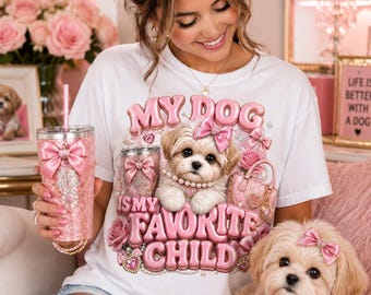 May include: A white t-shirt featuring a graphic of a fluffy puppy with a pink bow, a pink quilted handbag, and the text "MY DOG IS MY FAVORITE CHILD" in pink bubble letters. The shirt is paired with a matching pink glittery tumbler with a pink bow.