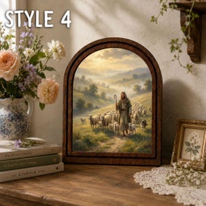 May include: An arched wooden frame containing a printed image of a shepherd walking with a flock of sheep through a misty, sunlit valley. The text "STYLE 4" is visible in the upper left corner of the image, which is displayed on a wooden surface.