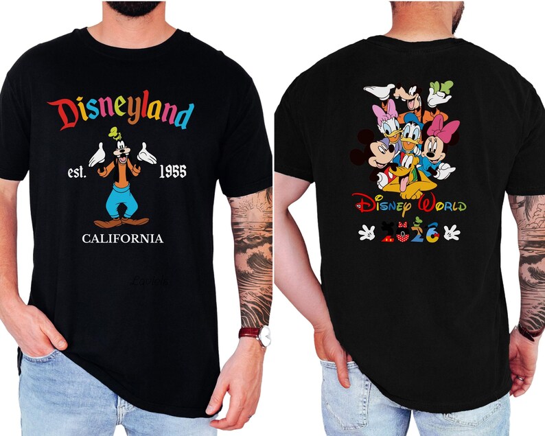 May include: A black short-sleeve t-shirt featuring a front graphic of Goofy with the text Disneyland est. 1955 CALIFORNIA. The back graphic displays a group of Disney characters above the text Disney World and the year 2026 with small icons.