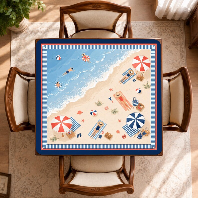 May include: A square tablecloth featuring a top-down beach scene with blue ocean waves, beige sand, and colorful umbrellas. The design includes people swimming, sunbathing on striped towels, beach balls, and bags, all framed by a navy blue border.