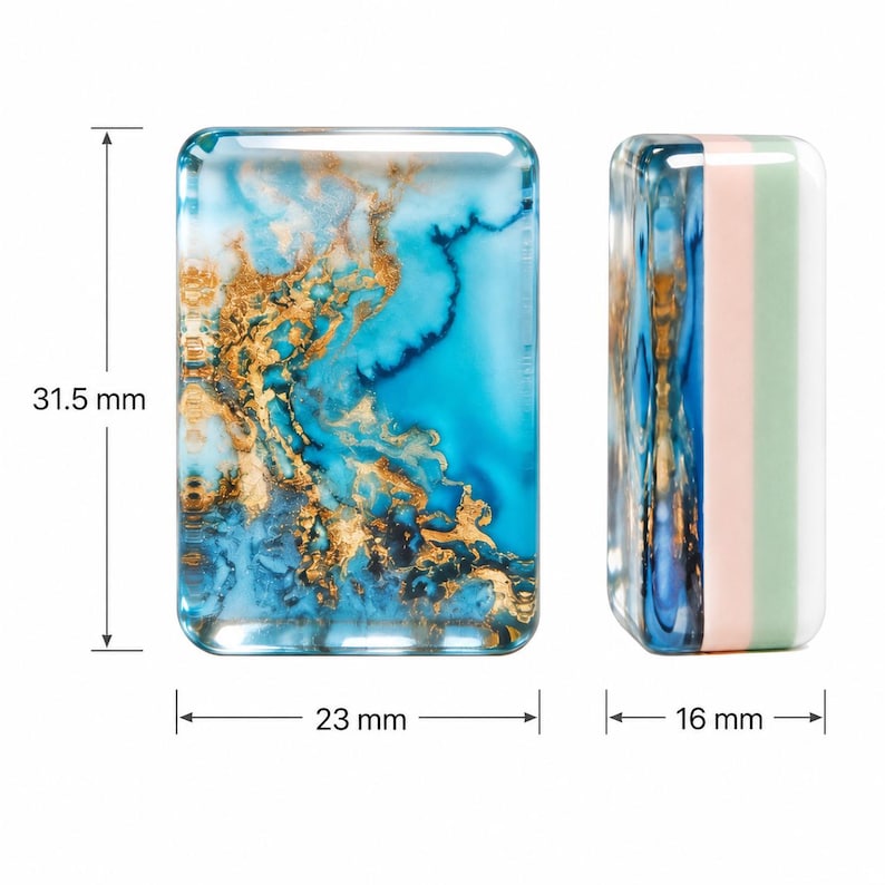 May include: Two rectangular resin blocks with rounded corners. The left block features a blue and gold marbled pattern, measuring 31.5 mm in height and 23 mm in width. The right block shows a side profile with blue, pink, and green layers, 16 mm wide.