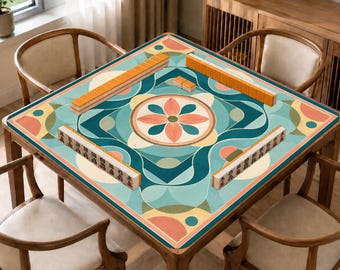 May include: A square mahjong mat featuring a geometric floral pattern in teal, light blue, peach, and cream. The mat is placed on a wooden table with four chairs and displays four rows of mahjong tiles arranged in a square formation on its surface.