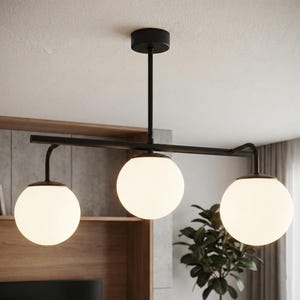 May include: A ceiling-mounted light fixture featuring a matte black horizontal metal bar suspended by a central rod. Three spherical white glass globes are attached to the bar, providing illumination. The design is linear with a black canopy.