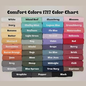 May include: A Comfort Colors 1717 color chart displaying a grid of folded t-shirts in various shades. The text at the top reads Comfort Colors 1717 Color Chart, followed by rows of labeled colors including white, ivory, banana, butter, mustard, terracotta, burnt orange, yam, grey, granite, island reef, chalky mint, seafoam, light green, bay, khaki, sage, moss, hemp, blue spruce, chambray, lagoon blue, flo blue, orchid, violet, grape, ice blue, blue jean, midnight, true navy, blossom, crunchberry, watermelon, heliconia, red, berry, brick, crimson, chili, espresso, graphite, pepper, and black.