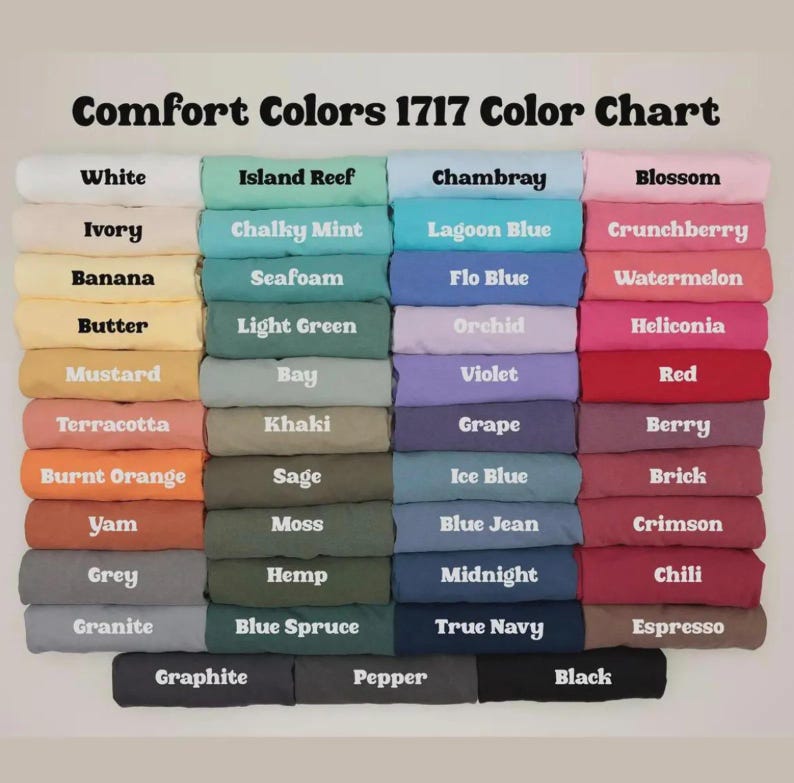 May include: A Comfort Colors 1717 color chart displaying a grid of folded t-shirts in various shades. The text at the top reads Comfort Colors 1717 Color Chart, followed by rows of labeled colors including white, ivory, banana, butter, mustard, terracotta, burnt orange, yam, grey, granite, island reef, chalky mint, seafoam, light green, bay, khaki, sage, moss, hemp, blue spruce, chambray, lagoon blue, flo blue, orchid, violet, grape, ice blue, blue jean, midnight, true navy, blossom, crunchberry, watermelon, heliconia, red, berry, brick, crimson, chili, espresso, graphite, pepper, and black.