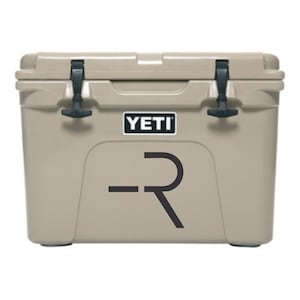 May include: A tan YETI cooler with a black "R" logo on the front.