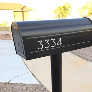 May include: A black mailbox with the number 3334 in white lettering on the front.