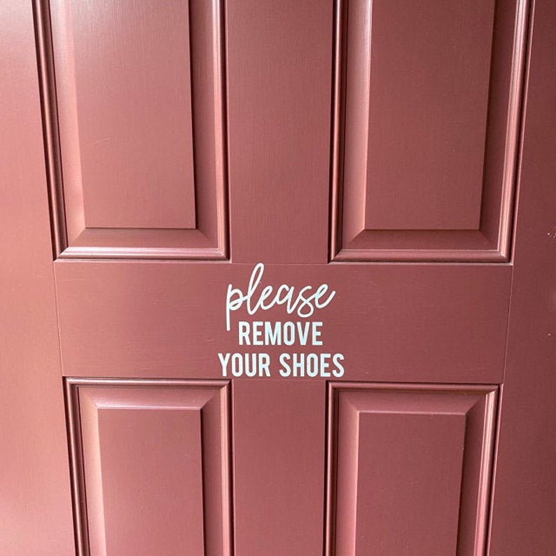 May include: A red wooden door with a white vinyl sticker that says "please remove your shoes".