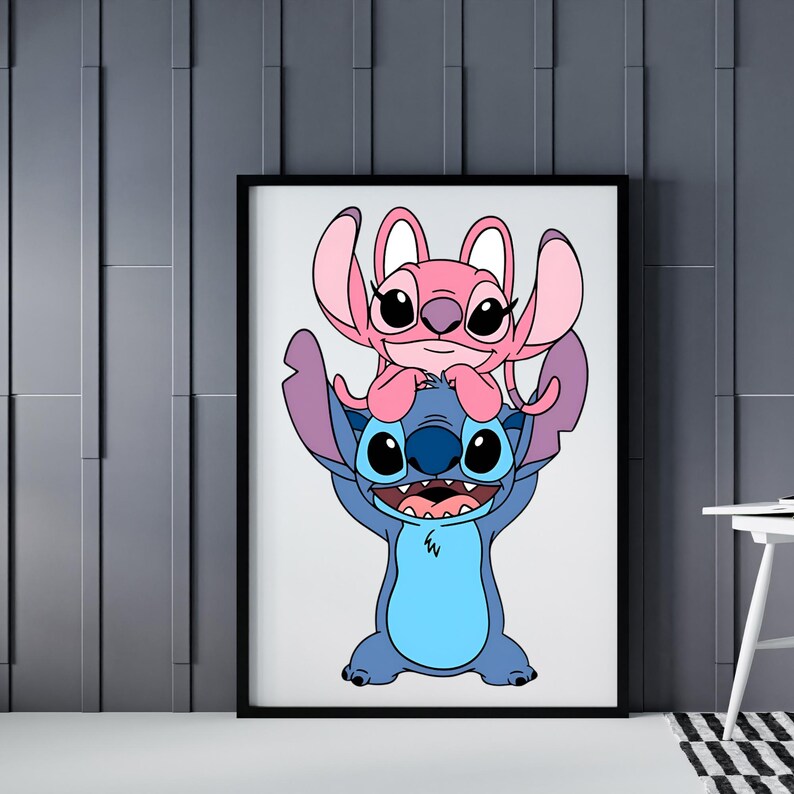 May include: Framed art print featuring the cartoon characters Stitch and Angel. Stitch, a blue alien, is holding Angel, a pink alien, above his head. The artwork is set against a white background within a black frame.