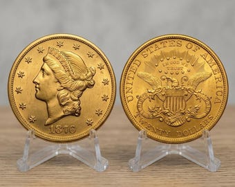 May include: Two gold-colored coins displayed on clear plastic stands. The left coin features a profile of Liberty with the year 1876. The right coin shows an eagle with a shield, the text UNITED STATES OF AMERICA, TWENTY DOLLARS, and IN GOD WE TRUST.