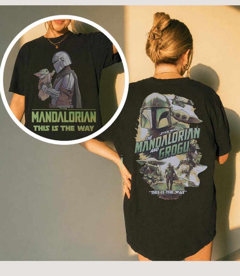 May include: A black t-shirt featuring a graphic print of The Mandalorian and Grogu. The back displays a large collage of the characters with the text "The Mandalorian and Grogu" and "This is the way." A circular inset shows the front design.