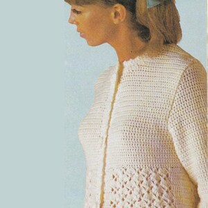 May include: A long-sleeved, off-white crochet cardigan featuring a solid stitch pattern on the upper bodice and a decorative diamond-shaped openwork pattern on the lower section, with a vertical front button closure and a round neckline.