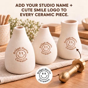 May include: Three off-white ceramic vases with a rounded base and narrow neck. Each vase features a stamped logo with the text Bridget Marrin Ceramics and a smiley face. A brass stamp tool with a matching logo design is positioned in the foreground.