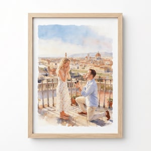 Op de afbeelding: Een aquarel in een lichthouten lijst met een huwelijksaanzoek op een balkon met uitzicht op een stad. Een persoon in een bloemenjurk staat, terwijl een ander in een lichtblauw overhemd en beige broek op de knieën zit met een ringdoosje.