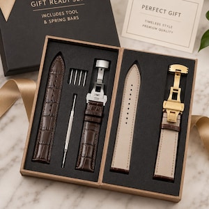 May include: A gift set containing two brown crocodile-textured watch straps with metal deployment clasps, a metal spring bar tool, and four spring bars. The box lid reads GIFT READY SET INCLUDES TOOL & SPRING BARS and a card reads PERFECT GIFT.