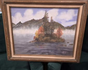 Blue Lake This vintage framed landscape oil painting captures a serene mountain lake. Delicate mist gently drifts across the water's surface