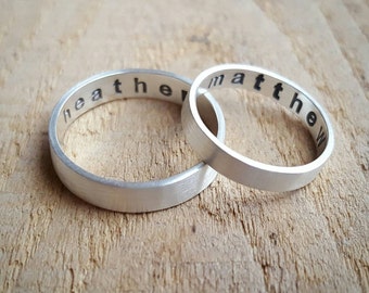 May include: Two silver rings with the names "Heather" and "Matthew" engraved on them.