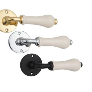 May include: Three door handles with cream-colored porcelain levers and circular backplates. The top handle has a polished brass finish, the middle handle has a polished chrome finish, and the bottom handle has a matte black finish.