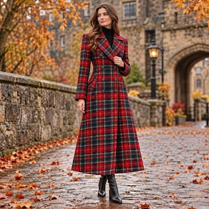 May include: A long, double-breasted coat featuring a red, green, and yellow plaid pattern. The coat has a structured collar, long sleeves, and a row of dark buttons down the front, extending to a full-length hemline over black boots.