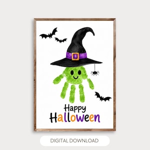 May include: A digital print featuring a green handprint character wearing a black witch hat with a purple band and yellow buckle. The design includes two black bats, a small spider, and the text Happy Halloween in black and orange.