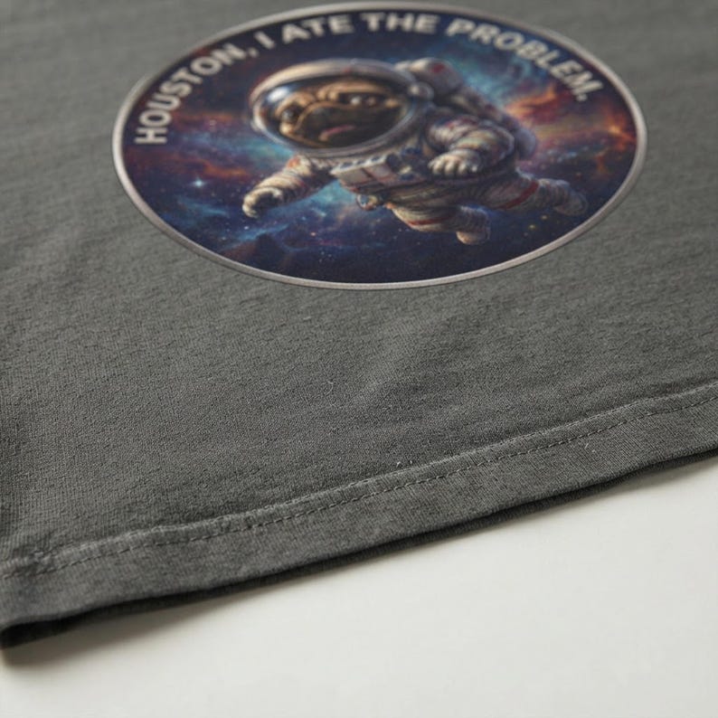 Close-up macro shot showing the soft garment-dyed texture and stitching of the heavyweight cotton t-shirt.
