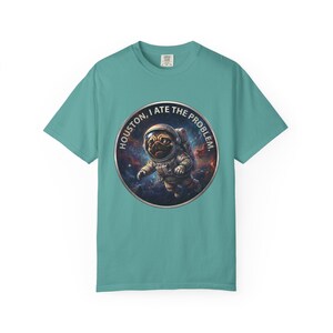 A teal crewneck t-shirt featuring the circular space pug graphic in the center.