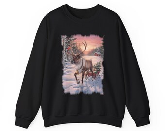 May include: A black crewneck sweatshirt featuring a central graphic print of a reindeer with a bell around its neck, pulling a small red sled loaded with gifts through a snowy forest landscape with a small cabin in the background.