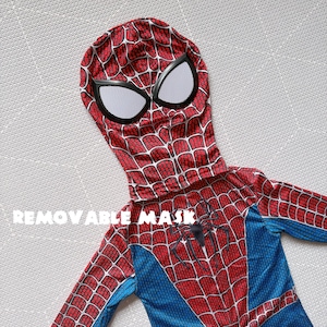 May include: A red and blue Spider-Man costume with a removable mask. The costume features a web pattern on the red areas and a spider emblem on the chest. The mask has white eye coverings.