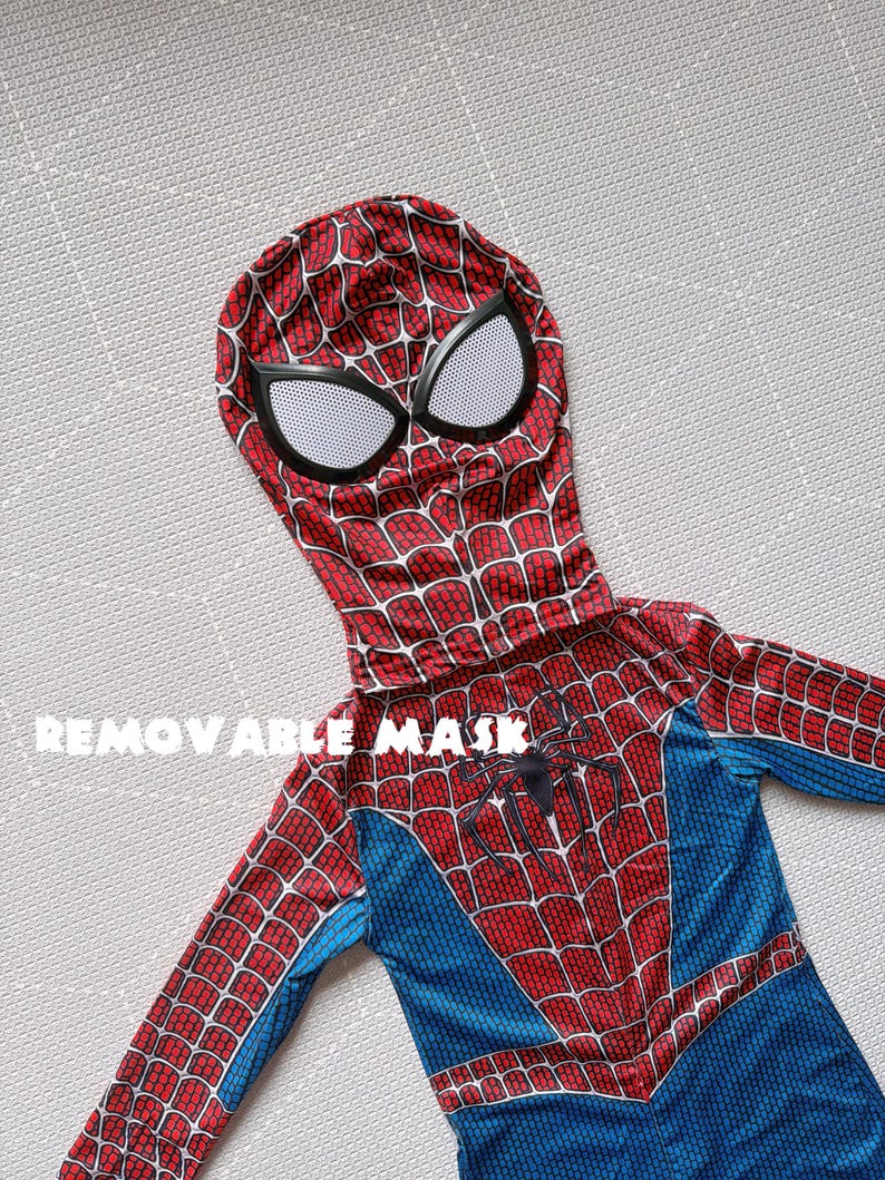 May include: A red and blue Spider-Man costume with a removable mask. The costume features a web pattern on the red areas and a spider emblem on the chest. The mask has white eye coverings.