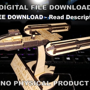 May include: A wooden model of a spaceship, with a brown and gold color scheme, is displayed on a laptop keyboard. The text "DIGITAL FILE DOWNLOAD" and "FREE DOWNLOAD - Read Description" is displayed above the model. The text "NO PHYSICAL PRODUCT" is displayed below the model.
