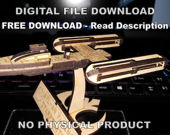 May include: A wooden model of a spaceship, with a brown and gold color scheme, is displayed on a laptop keyboard. The text "DIGITAL FILE DOWNLOAD" and "FREE DOWNLOAD - Read Description" is displayed above the model. The text "NO PHYSICAL PRODUCT" is displayed below the model.