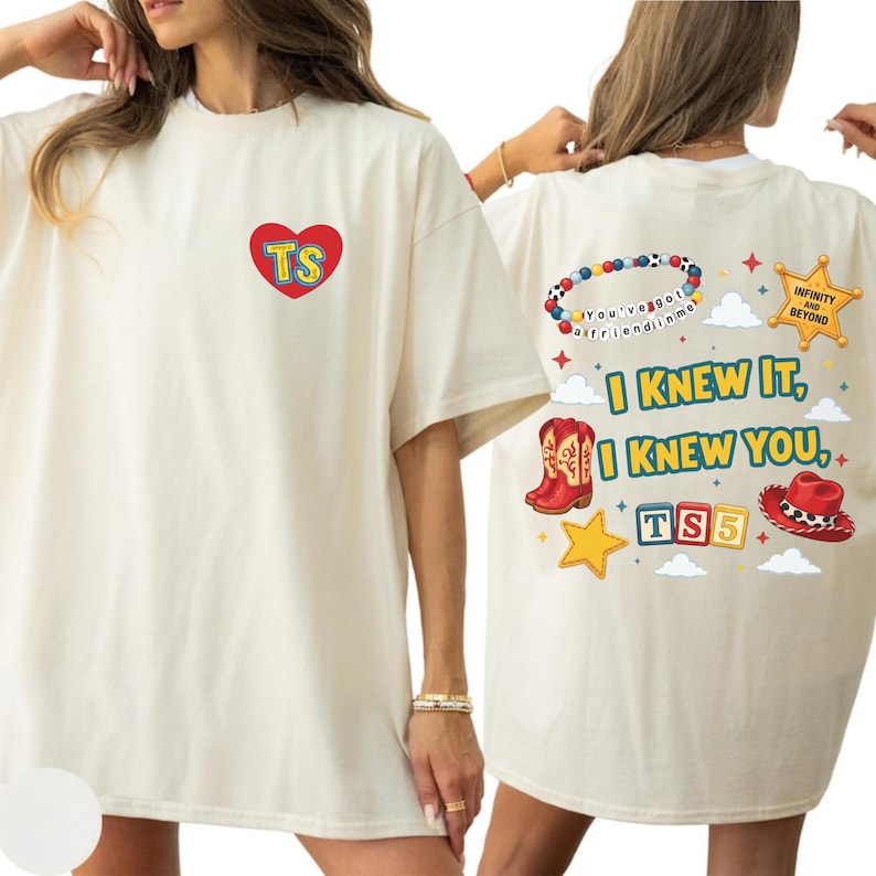 May include: An off-white t-shirt featuring a red heart with the letters TS on the front. The back displays a beaded bracelet, a sheriff badge with the text Infinity and Beyond, red cowboy boots, a red hat, and the text I Knew It, I Knew You, TS5.