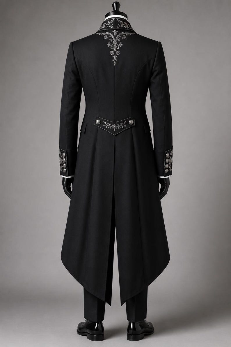 Royal Black Gothic Long Coat Set featuring a Victorian embroidered tailcoat suit with intricate silver floral embroidery on the lapels and cuffs. Elegant aristocrat wedding outfit includes a matching waistcoat, formal trousers, and classic cravat, creating a sophisticated gothic wedding coat look. This cotton trench coat-inspired design is ideal for Victorian events, Gothic weddings, masquerade balls, formal occasions, steampunk gatherings, and aristocratic cosplay.