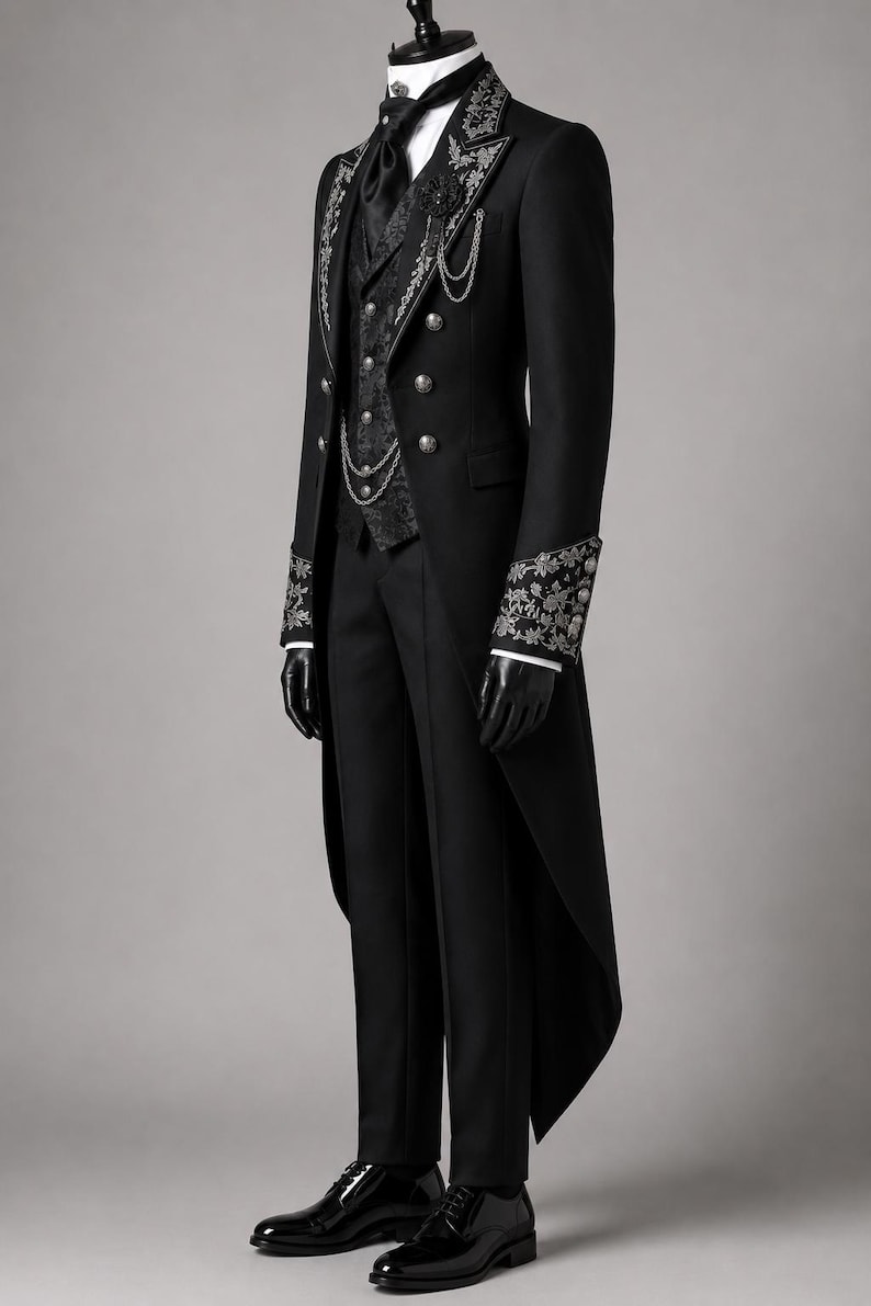 Elegant black Victorian embroidered tailcoat suit designed for gentlemen seeking a refined aristocrat wedding outfit. Featuring ornate silver embroidery, structured tailoring, decorative chains, and a formal waistcoat, this gothic wedding coat blends historical fashion with modern sophistication. Inspired by classic cotton trench coat styling, it is perfect for Gothic formal wear, Victorian-themed events, cosplay, and luxury weddings.