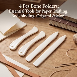 May include: A set of 4 white bone folders for paper crafting, bookbinding, and origami. The text reads: 4 Pcs Bone Folders: Essential Tools for Paper Crafting, Bookbinding, Origami & More. These smooth, flat tools are designed for creasing paper.