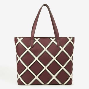 May include: A deep burgundy tote bag featuring a prominent white lattice pattern across the front. The bag has two matching burgundy shoulder straps and a structured rectangular shape with a clean, geometric design throughout the exterior.