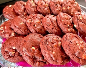 May include: A platter of red velvet cookies filled with white chocolate chips. The cookies are arranged in a circle on a clear glass platter with a pink rim. The text "Stuffed Red Velvet Cookies - Appx. 3-1/3 lbs" is written on a pink banner at the bottom of the image.