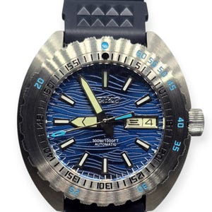 May include: A stainless steel wristwatch with a blue wave-patterned dial. The watch features luminous hands and markers, a date display, and a black rubber strap. The bezel has minute markers and a rotating design. The watch is water-resistant to 300 meters.