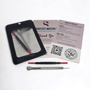 May include: A black pouch with a clear window containing a metal tool, a black and red spring bar tool, and a silver precision screwdriver. Two informational cards from Sond City Watches are included, featuring text, a QR code, and a circular logo.